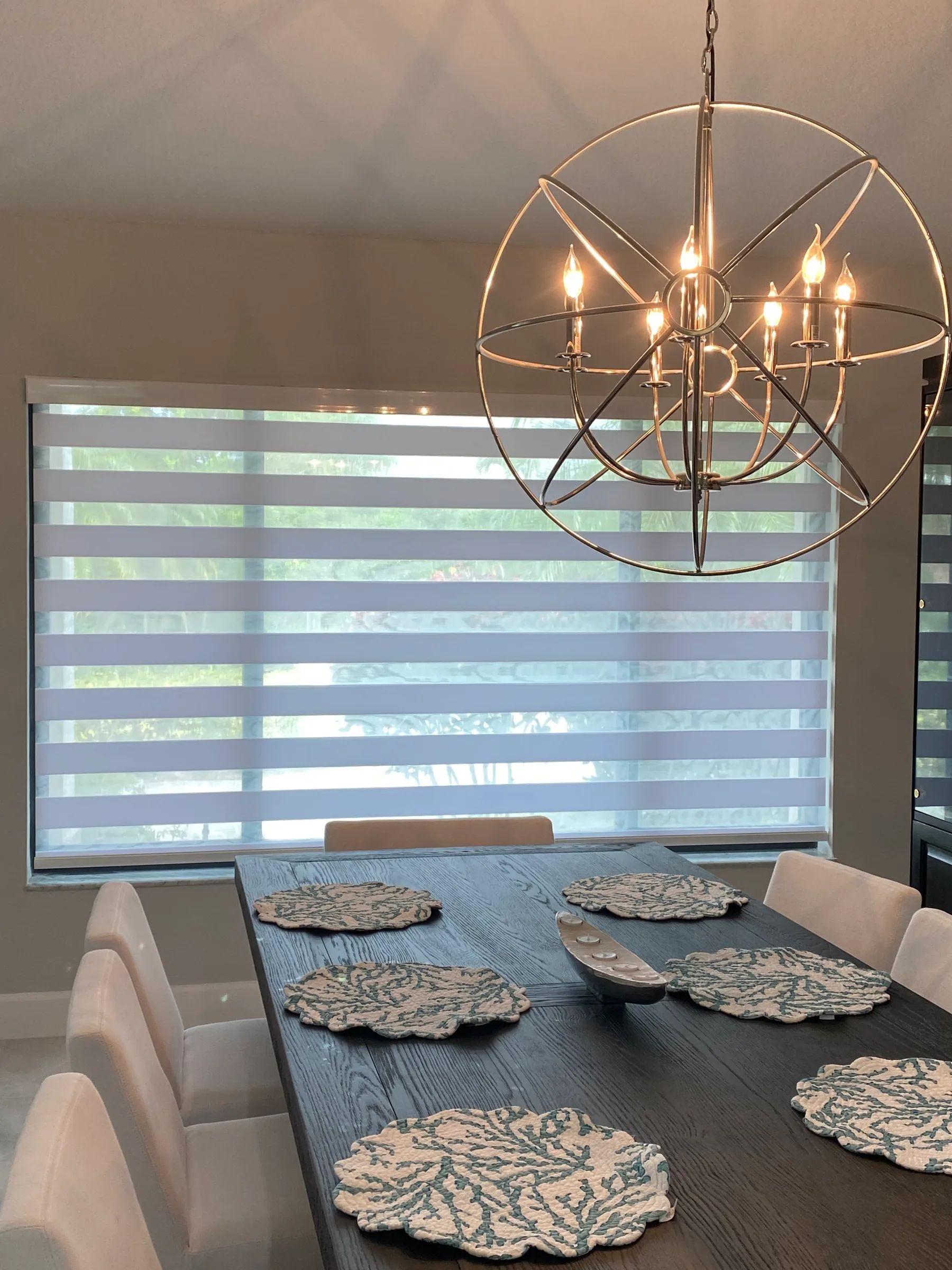 A kitchen with a sink and window blinds