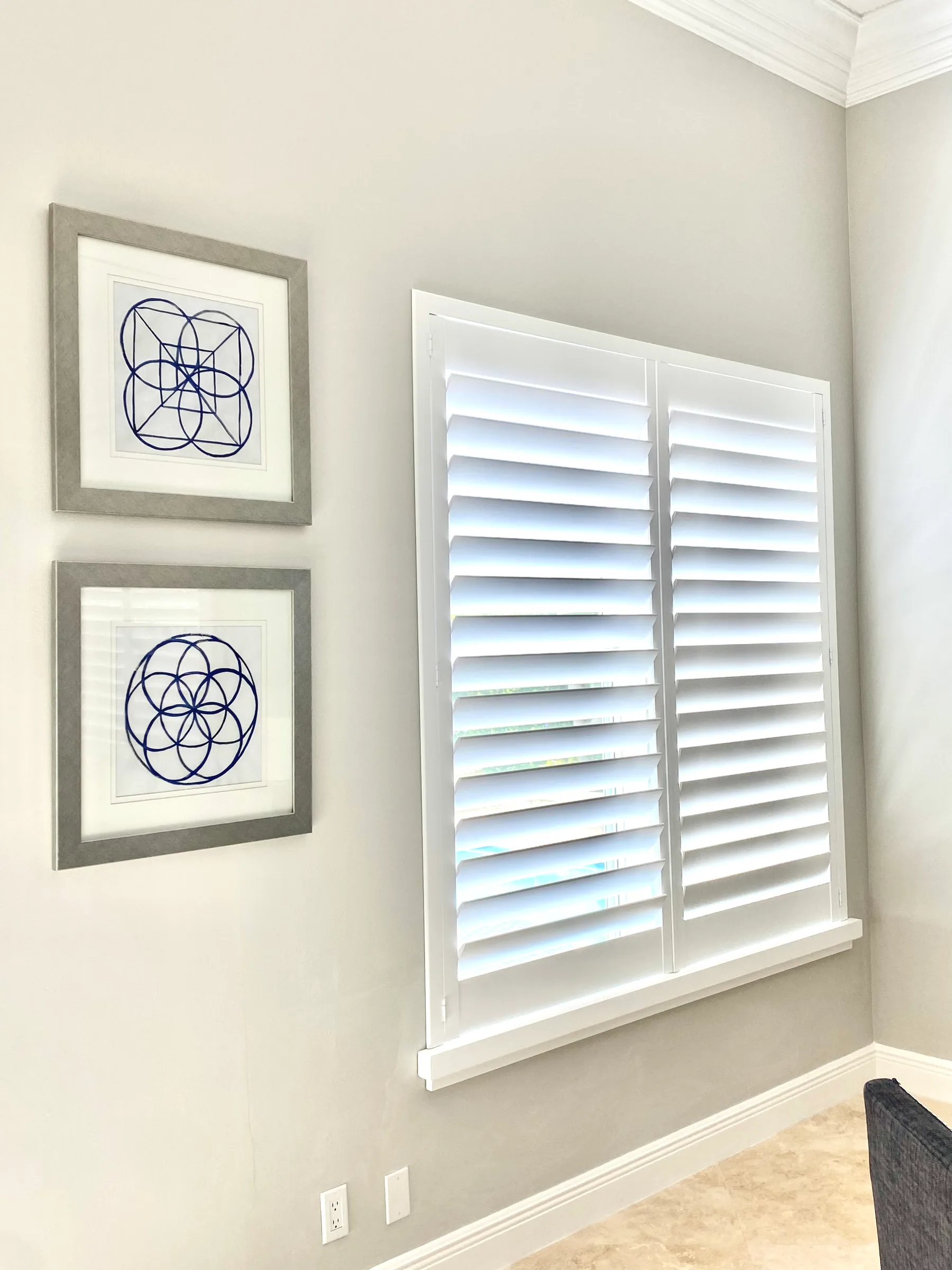 A window with shutters open and closed.